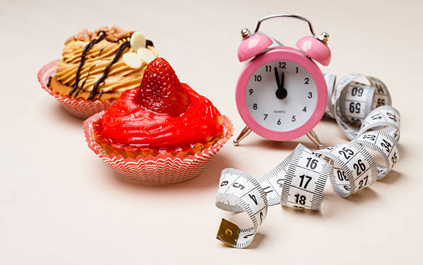 istock Sweet food measuring tape and clock on table 519754638