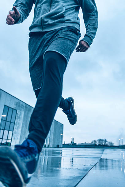 istock Close up of runner who runs fast outside in rain 519754984