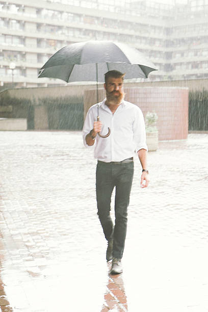 istock Businessman With Umbrella In The Rain 519755114
