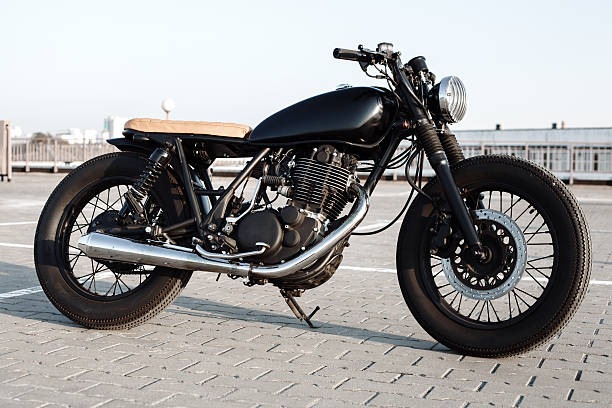 istock Vintage motorcycle in parking lot during sunset 519755144