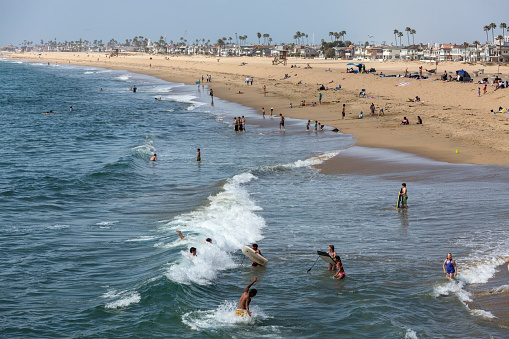 Santa Monica, California, USA  - March 18, 2014: Tourists, local residents and families gather in the sunshine on Santa Monica Beach
