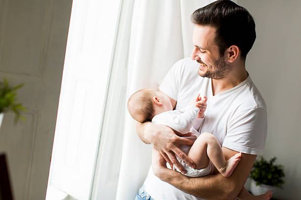 istock Man holding a baby 519758982