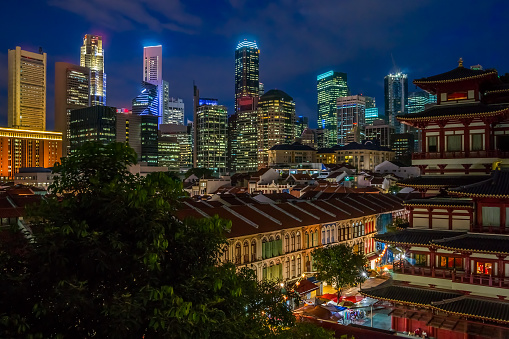 View to the impressive skyline of Singapore's central business district over Chinatown at the blue hour.