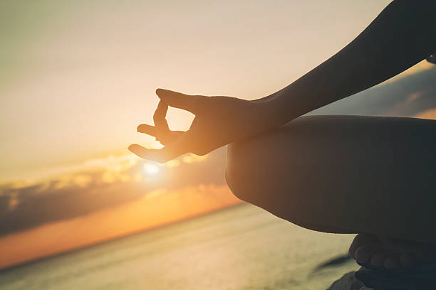 istock Young woman practicing yoga on the beach. 519761328