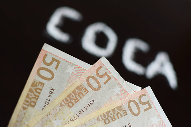 istock Banknote and text COCA blurred  written with cocaine power 519761904