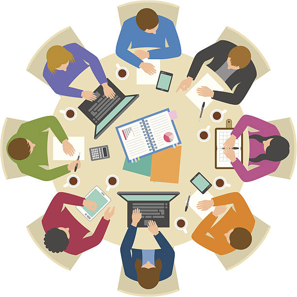 Overhead view of people discussing at round table Office workers working hard at round table from directly above conference table stock illustrations
