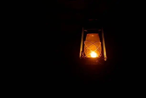 Old windproof lamp shine in the dark.
