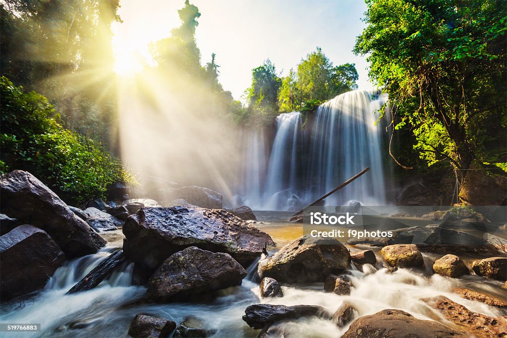 Tropical waterfall Tropical waterfall with sun rays in Cambodia Asia Stock Photo