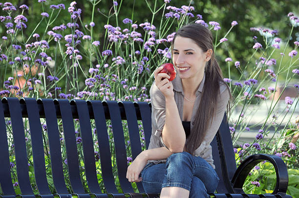 istock Beautiful girl sitting on bench in park 519767803