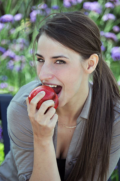 istock Pretty woman eating an apple 519769169