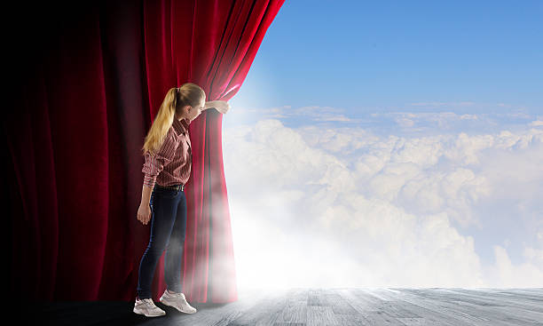 istock Girl opening curtain 519770025