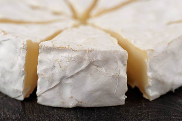 istock Head of brie cheese cut in pieces 519783256