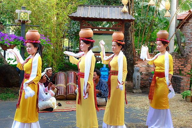 Hochiminh City, Vietnam - March 5, 2016: a folk dances of the Cham people in which the girls carry ceramic water jugs dancing at the culinary fair in the resort Van Thanh, Ho Chi Minh city