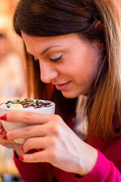 istock Woman holding a glass cup with cocoa and marshmallow 519784372