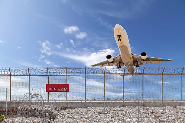 istock Restricted area fence  and Passenger airplane landing. 519789276