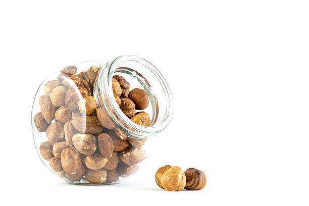 istock hazelnuts in a glass jar isolated on white 519789788