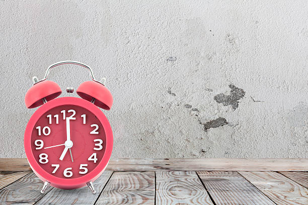 istock Red alarm clock on a wooden table 519789868