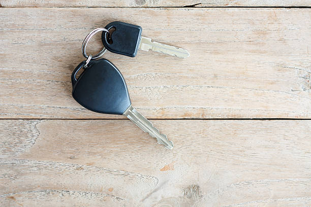 Car Key on wood background Car Key on wood background car keys table stock pictures, royalty-free photos & images