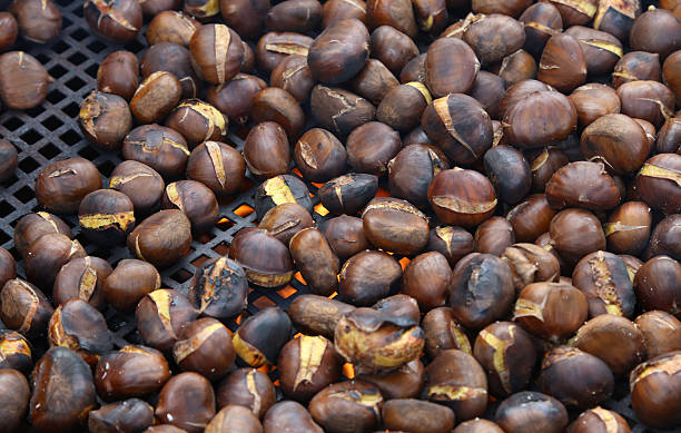 istock chestnuts roasted in giant pan on the fire 519793604