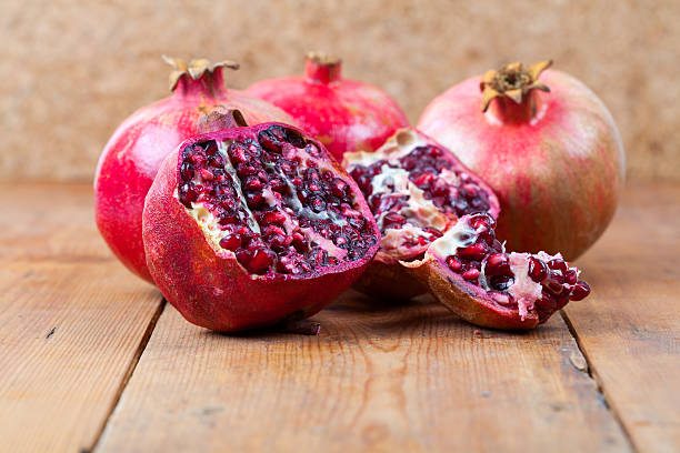 istock Fresh pomegranate fruit on wooden surface 519801777