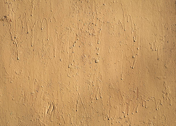 istock Texture of old  wall covered with yellow stucco 519803285