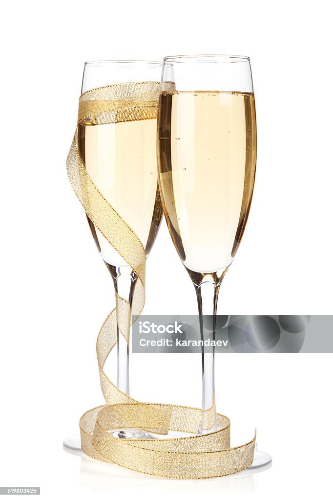 Champagne glasses with golden ribbon Champagne glasses with golden ribbon. Isolated on white background Champagne Stock Photo