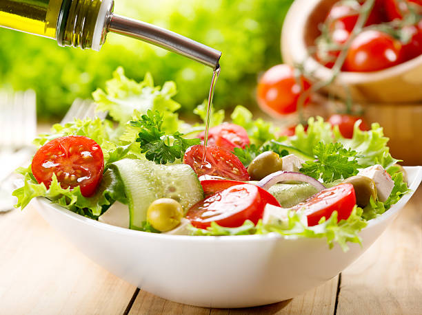 istock olive oil pouring over salad 519805541