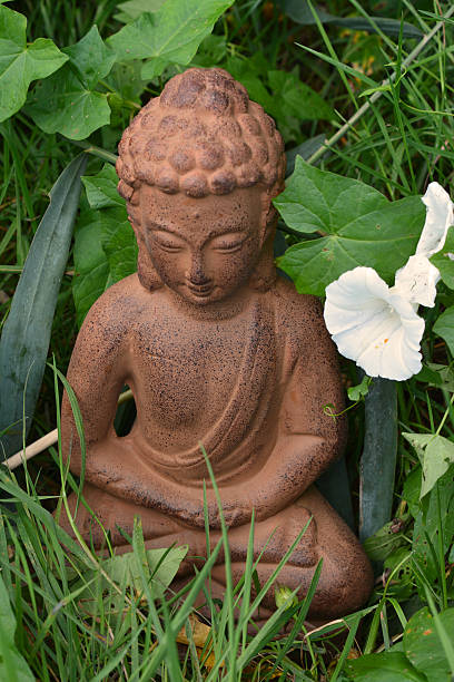 istock Buddha stature in a green garden with reed 519805937