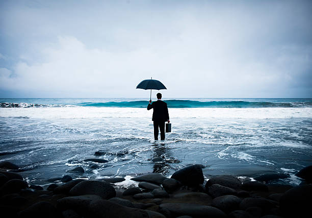 istock Lonely Businessman Alone on the Beach 519808577