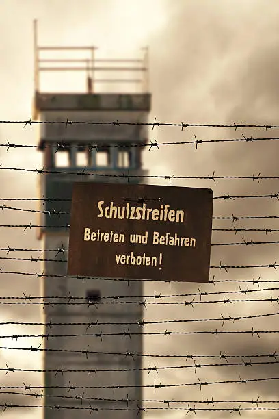 Watchtower with barbed wire and prohibition sign at the former inner German border