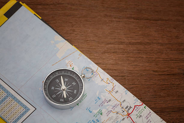 istock compass on old wood background with space for text, 519822960