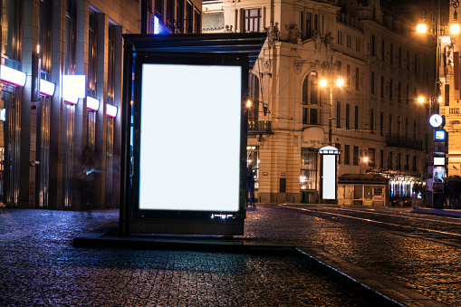 billboard at bus stop at night
