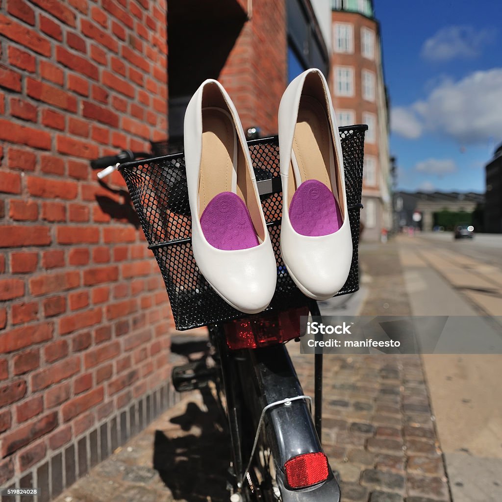 Bridal shoes on bicycle at street White Bridal shoes on bicycle basket at street of Copenhagen, Denmark Adult Stock Photo