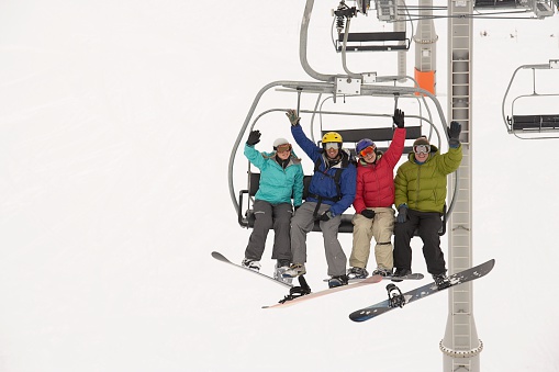 Snowboarders on a ski lift