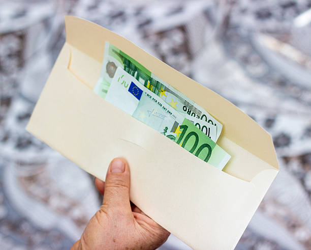 istock Group of one hundred euro banknotes in envelope 519826656
