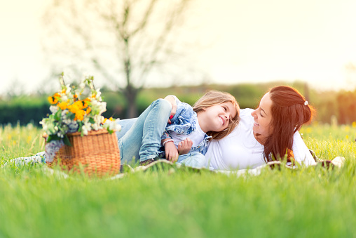 Mother and daughter resting in nature