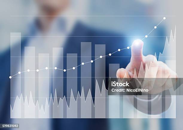 Expert Businessman Using Business Intelligence To Sketch Success On Charts Stock Photo - Download Image Now