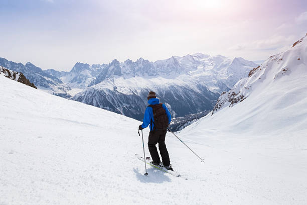 Skier skiing on snowy slope in Alps mountains near Chamonix Skier skiing on red slope in Alps mountains near Chamonix, France auvergne rhône alpes photos stock pictures, royalty-free photos & images