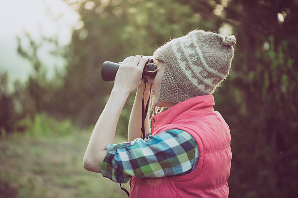 istock Hiker looking in binoculars enjoying view in forest 519831944
