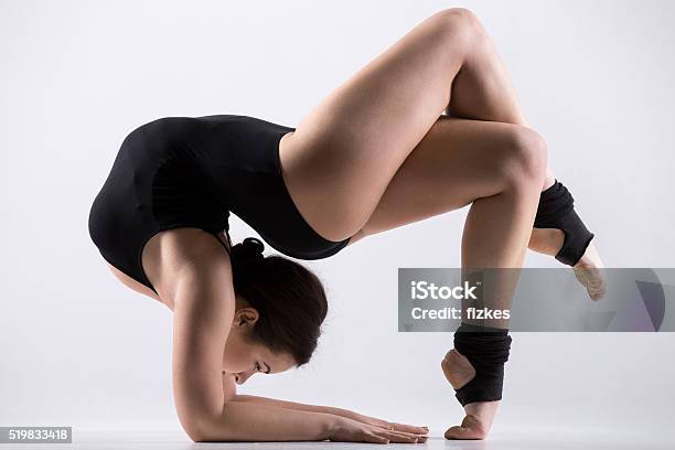 Young Woman Doing Acrobatic Exercise Stock Photo - Download Image Now - Acrobat, Active Lifestyle, Activity