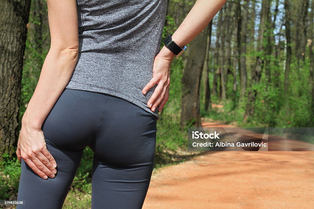 Woman  runner with Cramp in the Hamstring Muscles Running, sport injury. Woman  runner with Cramp in the Hamstring Muscles Pain Stock Photo