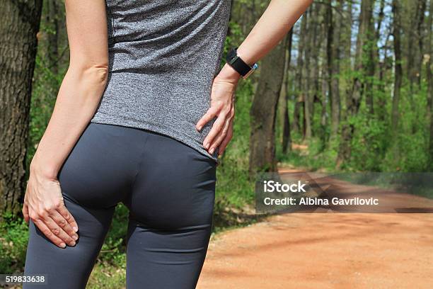 Woman Runner With Cramp In The Hamstring Muscles Stock Photo - Download Image Now - Pain, Buttocks, Hamstring