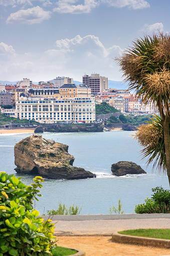 Biarritz - located at the Gulf of Biscay, South West France(Pyrenees-Atlantiques, Aquitaine). View from the Pointe St. Martin down to the beach. The promenade in the foreground. The Grande Plage is famous for the most important european surf events. Spring day with changeable showery weather. Sunshine alternated with heavy rain by the hour.