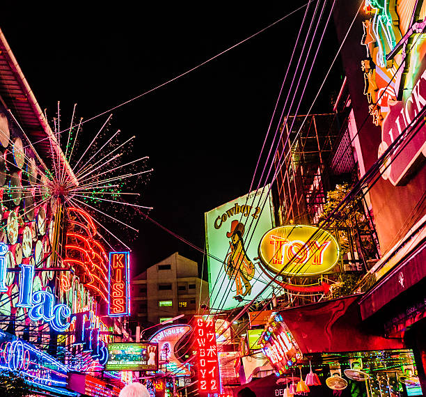 soi cowboy quartiere a luci rosse di bangkok tailandia - prostitution night horizontal outdoors foto e immagini stock