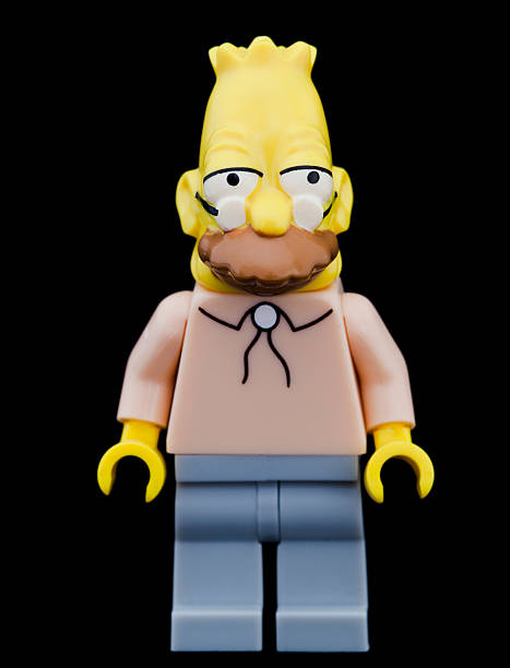 Studio shot of a Lego Mini Figure, Abraham Simpson. Taastrup, Denmark - April 9, 2016: Studio shot of a Lego Mini Figure, Abraham Simpson, Homers father from The Simpsons. Isolated on black background. father abraham stock pictures, royalty-free photos & images