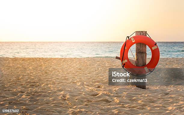 Life Preserver On Sandy Beach Stock Photo - Download Image Now - Life Belt, Beach, Buoy