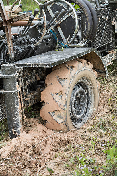 istock Car's wheels in mud in the forest 519847057