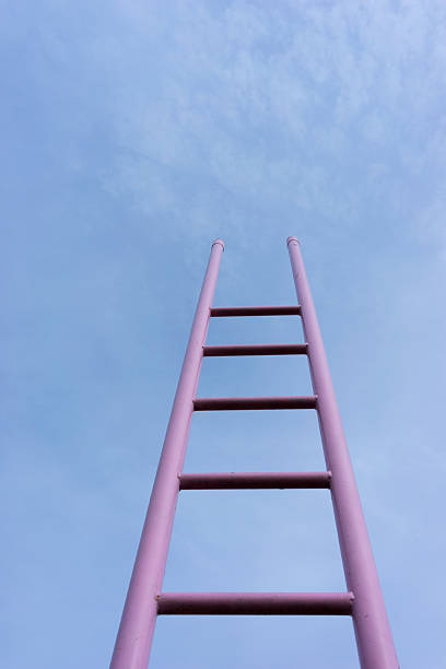 istock Pink ladder in the blue sky 519847243