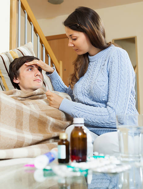 istock Woman caring for sick guy who high temperature 519847283