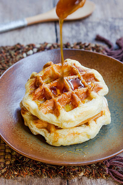 istock Honey pouring on a fresh waffles. 519848455